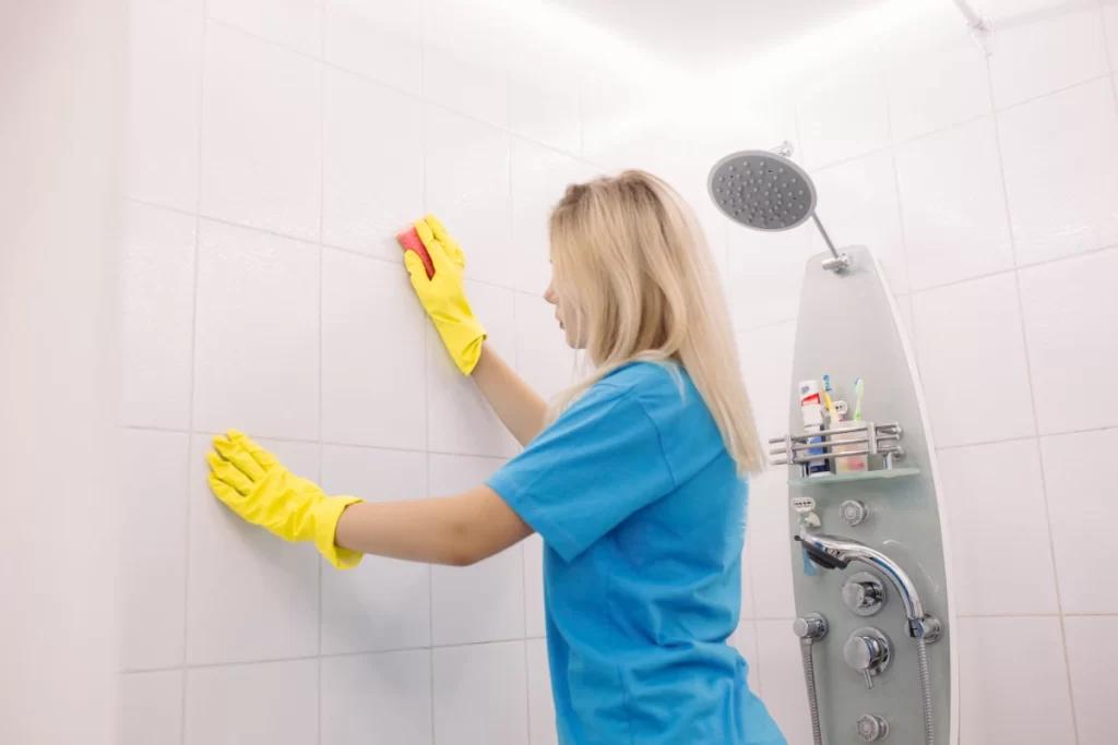 Worker Cleaning Bathroom Tiles in Leicester