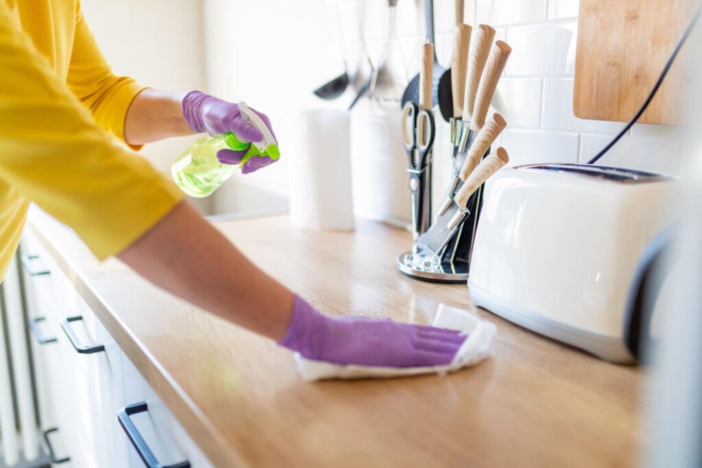Worker Cleaning the Kitchen Tile in Boylston